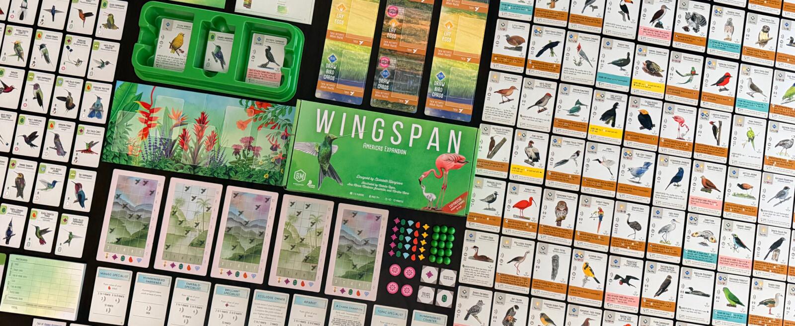 Board game 'Wingspan' with cards and components on a checkered surface